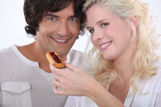 Woman feeding her boyfriend a biscuit