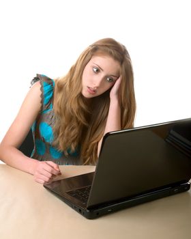 girl-teenager sits at the laptop on a white background