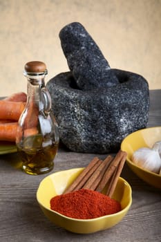 Stone mortar and spices on a wooden table