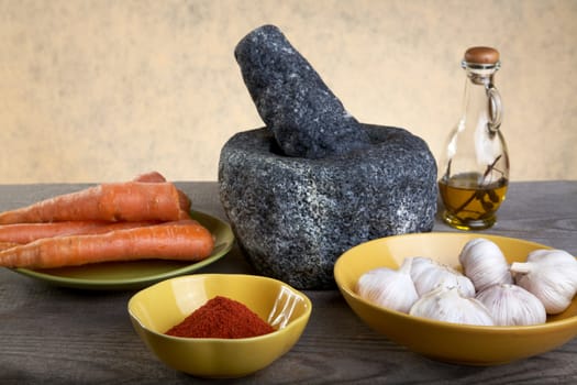 Stone mortar and spices on a wooden table