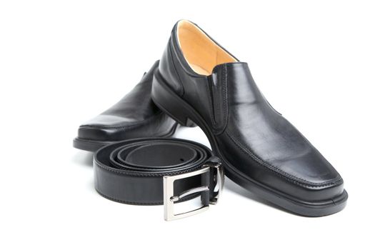 pair black man's shoe and a belt on  white background