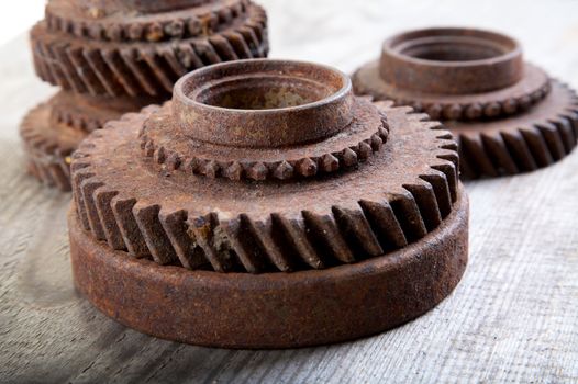 Rusty iron gear wheels on a board