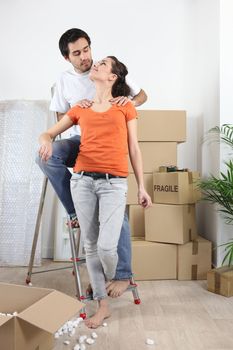 Couple happy to have finally moved into new flat