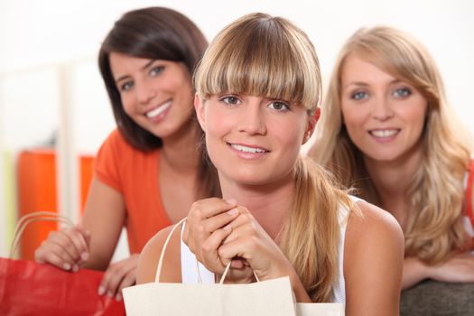 three female friends at home with shopping bags