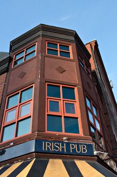 Old building with a sign on front that reads Irish Pub.