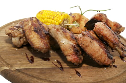 Chicken wings grilled with vegetables and corn