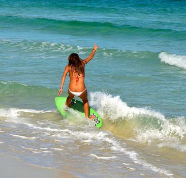 curvaceous young woman skimboard surfing at southpointe park onMiami Beach







curvaceous  bikini clad young woman skimboard