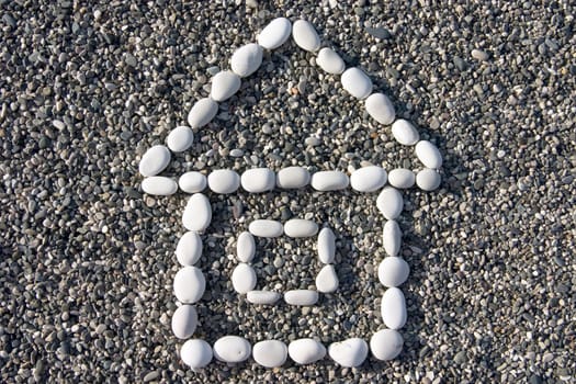 small house made of white stones on a background of a coastal pebble