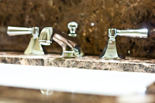 Tap in an Italian luxury hotel, steel on marble