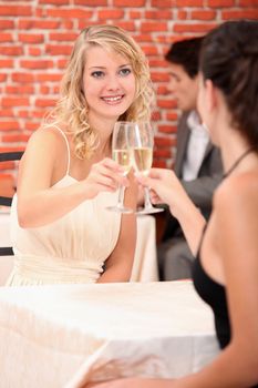 Girls drinking champagne in a restaurant