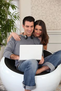 Young casual couple looking at a laptop