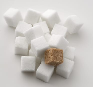 stack of white sugar cube with one brown sugar cube