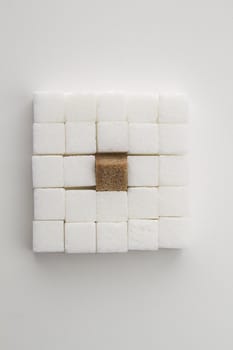  white sugar cube with one brown sugar cube place in a square shape