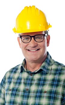 Closeup of senior architect in hardhat ssmiling in front of camera