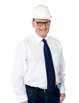 Handsome smiling aged engineer with hard hat on his head isolated on white