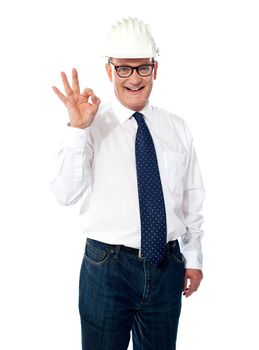 Mature builder showing approval gesture isolated over white