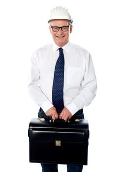 Handsome senior builder holding briefcase isolated against white
