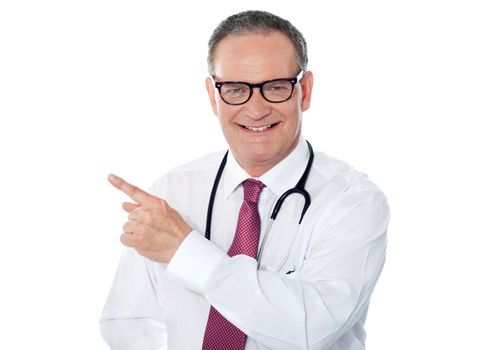 Medical professional pointing away. Stethoscope around his neck