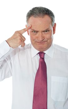 Confused matured corporate man with finger on his head