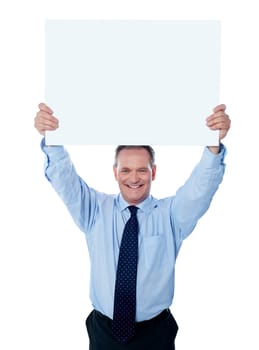 Businessman holding a blank billboard over the head, isolated on white