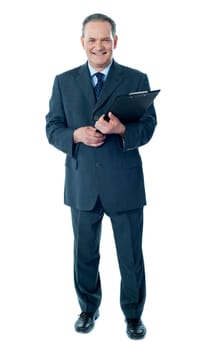 Corporate senior holding business documents, full length portrait