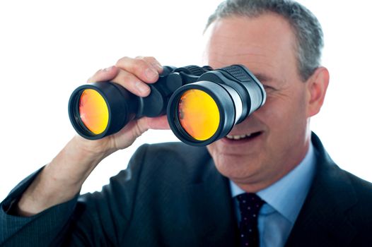 Senior man observing through binoculars isolated over white background