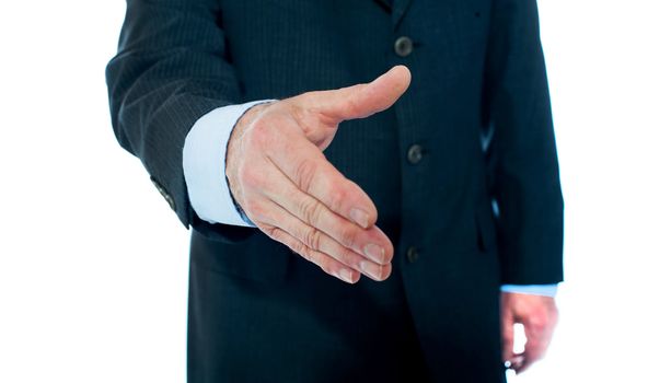 Close-up of businessman offering hand for handshake. Isolated on white background