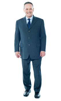 Full length view of senior corporate male posing in front of camera