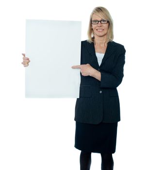 Business woman displaying placard to camera. Smiling and isolated