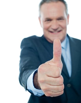 Matured businessman showing thumbs-up gesture isolated on white