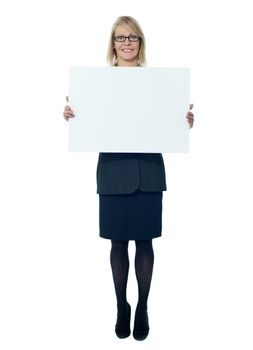 Company secretary holding blank white billboard, in studio
