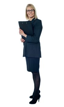 Corporate woman holding business documents, full length portrait