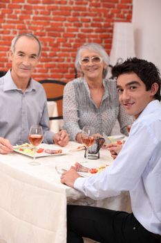 grandparents and grandson eating at restaurant