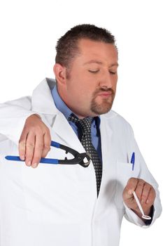 Dentist holding mirror and pliers
