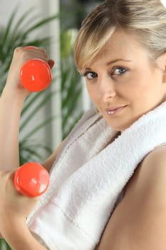 woman doing exercises with dumbbells