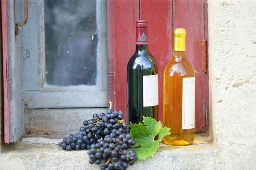 Two bottles of wine on rustic windowsill