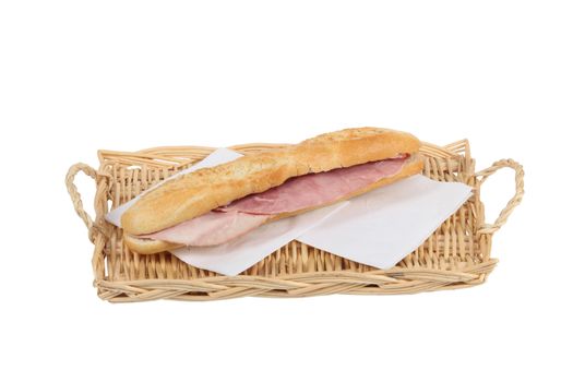 Simple ham baguette on a wicker tray