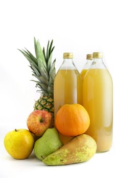 Various fruits by glass juice bottles