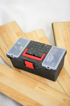 Tool box resting on laminate floorboards