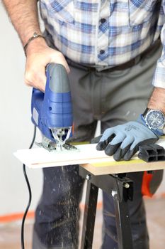 Carpenter using electric saw