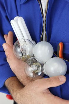 Electrician holding lightbulbs