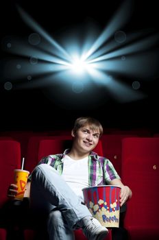 man in a chair watching a movie