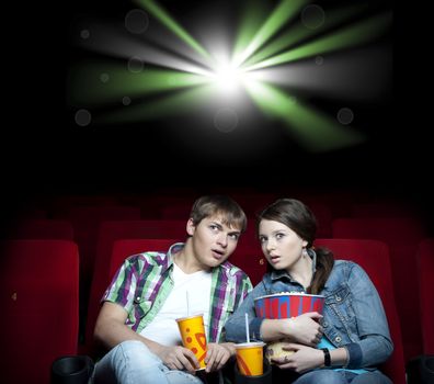 couple in a movie theater, watching a movie