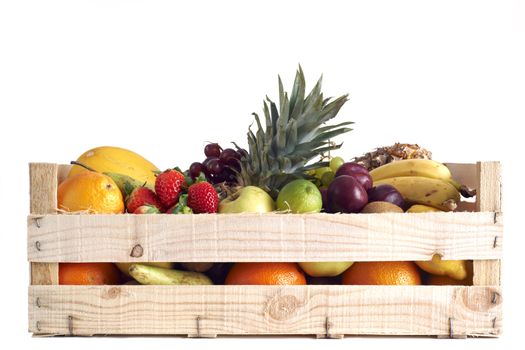 Various types of fruit stored in wooden box on white background