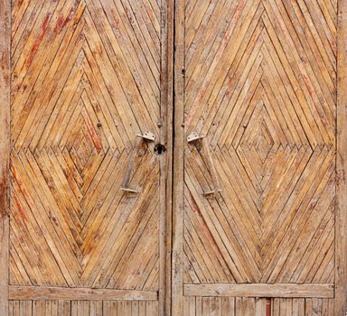 Vintage wooden door under the evening sun light 	
