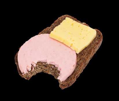 Bitten black bread with cheese and sausage