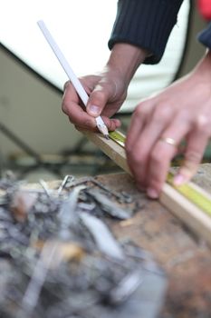 Builder marking wood with a pencil