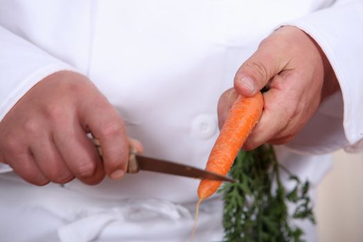 Chef cutting a carrot