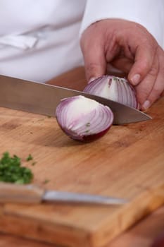 Chef chopping an onion