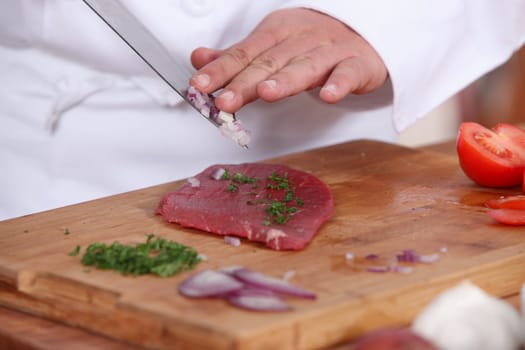 cook preparing steak